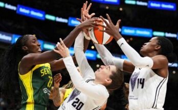 The Golden State Valkyries Kate Martin (20) goalkeeper has trouble maintaining possession against the Seattle Storm striker Ezi Magbegor (left) while the center of Valkyries TEMI Fagbenle (14) reached the ball in the second half of a WNBA match in Seattle. The Valkyries made their debut this season as 13th League team.