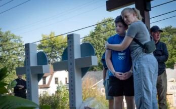 The members of the community visit a memorial to shoot the victims before the Catholic Church of Annunciation in Minneapolis, one day after a shooter opened fire on students and parishioners during a Catholic school mass.